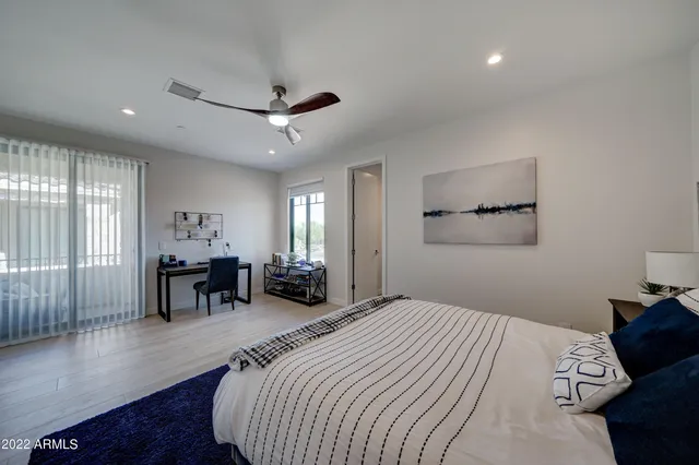 a bed room with a bed and a chair