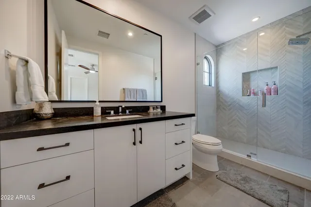 a bathroom with double sink and a mirror