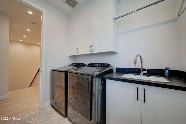 a kitchen with a sink and cabinets