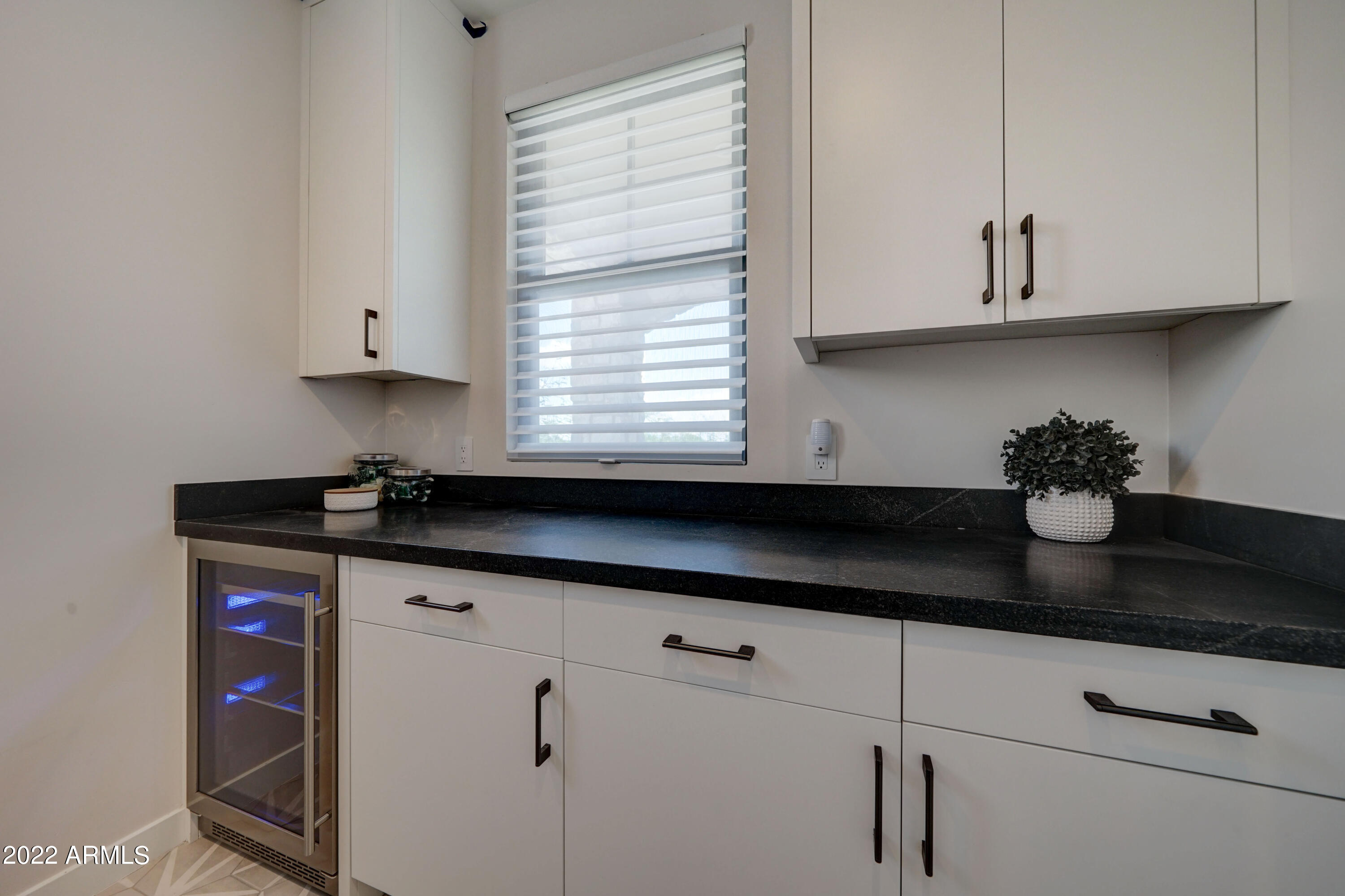 6500 East Camelback Road, Unit 1006 Scottsdale, AZ 85251 - Photo 25 of 38 a kitchen with granite countertop white cabinets and a stove