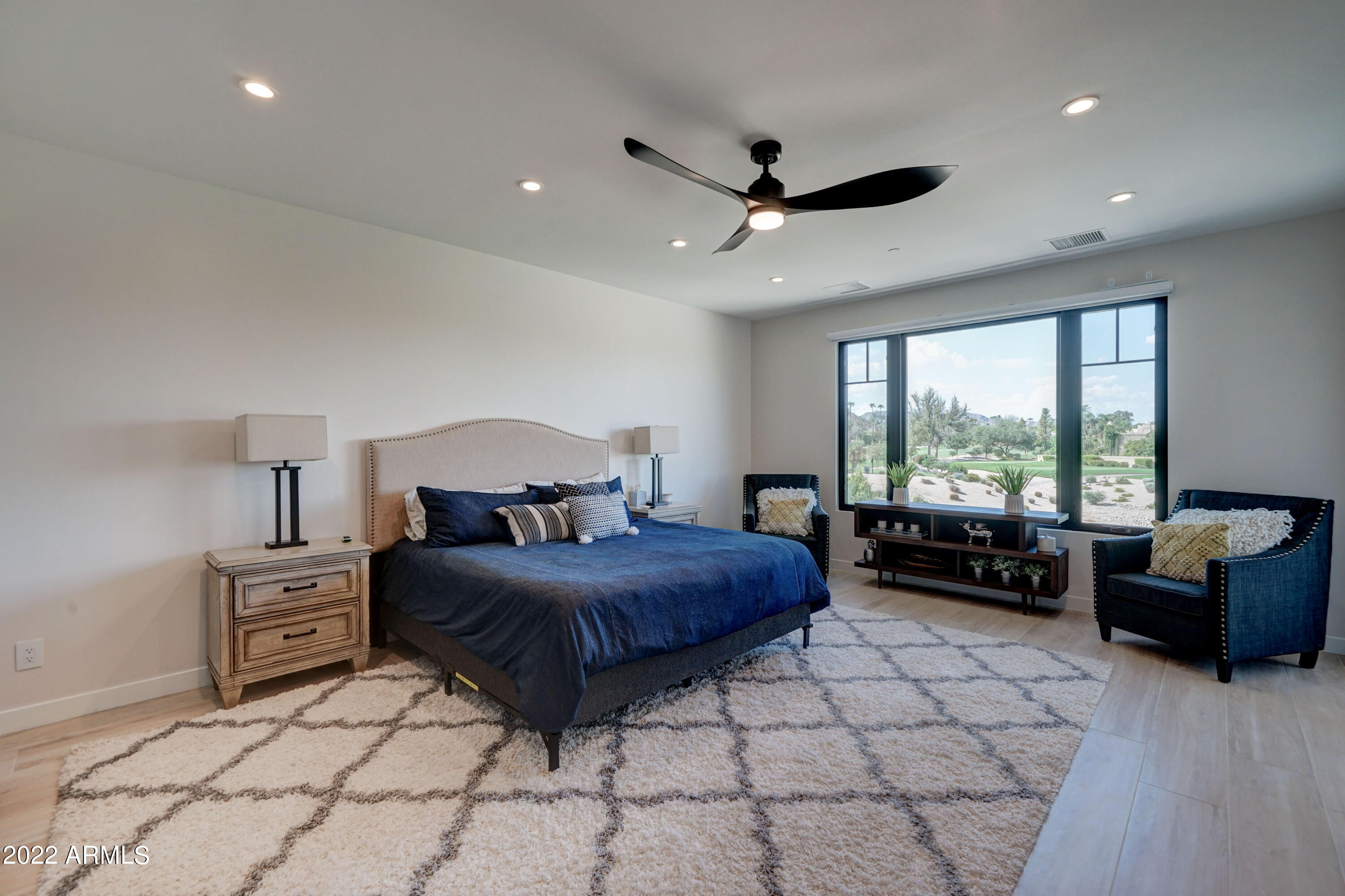 6500 East Camelback Road, Unit 1006 Scottsdale, AZ 85251 - Photo 26 of 38 a bedroom with a bed and glass window