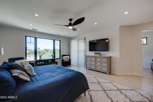 a bedroom with a bed and a flat screen tv