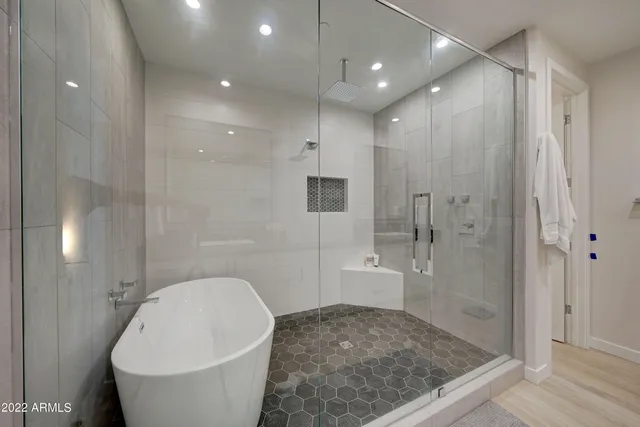 a spacious bathroom with a granite countertop sink a toilet and shower