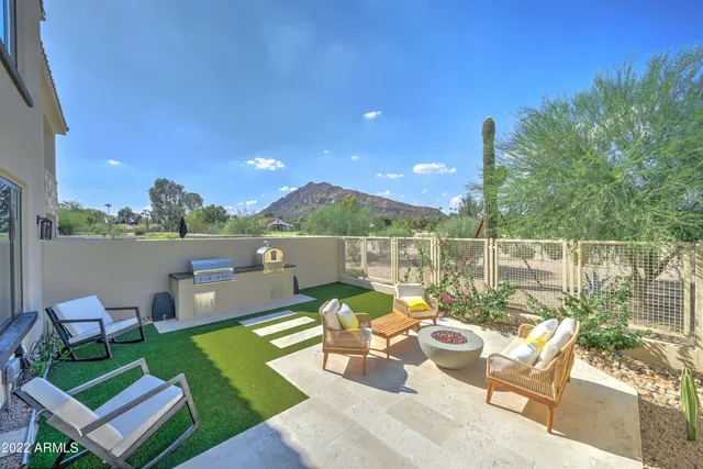 a view of a patio with couches chairs and a table and chairs with wooden floor