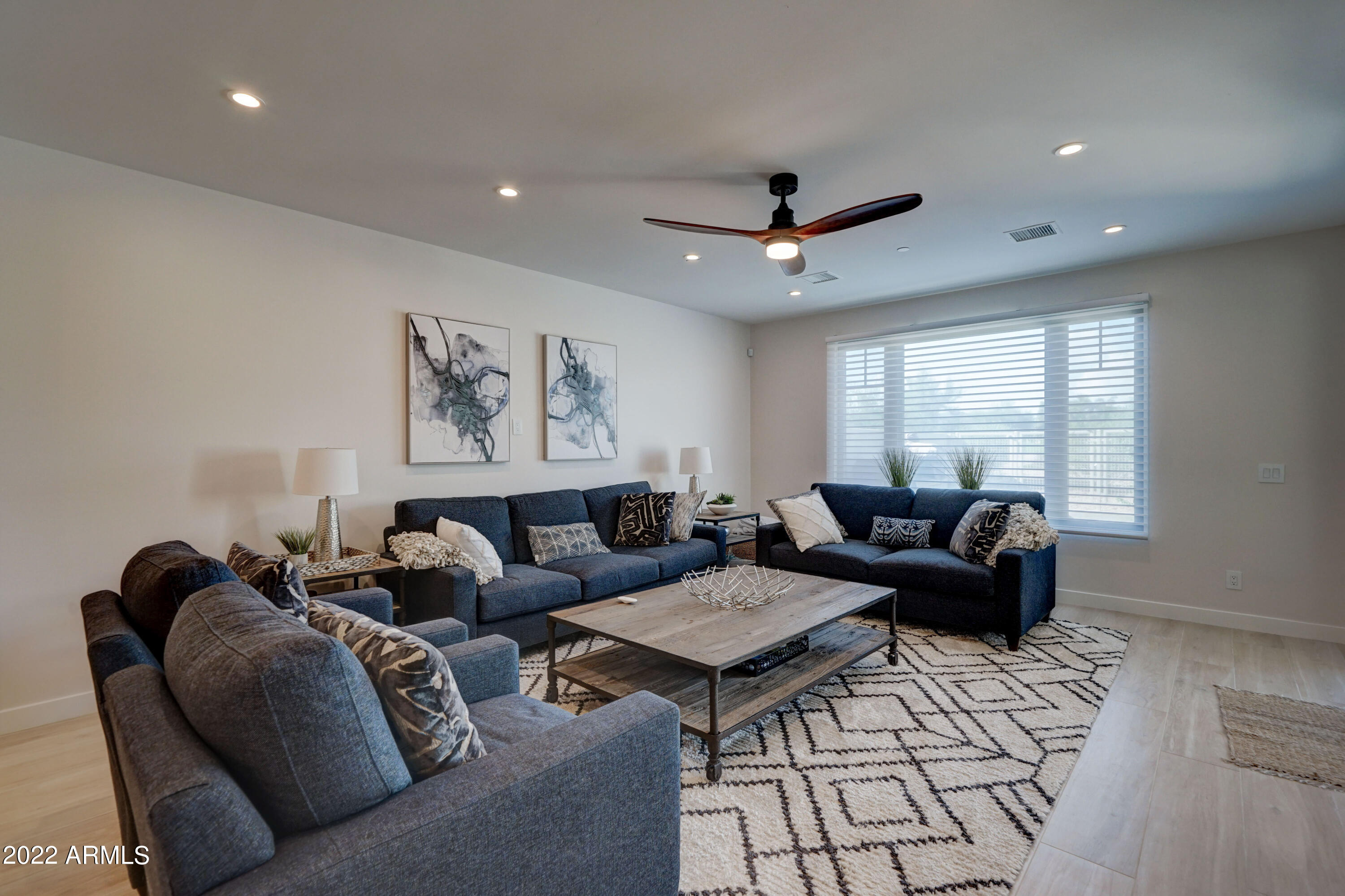 6500 East Camelback Road, Unit 1006 Scottsdale, AZ 85251 - Photo 7 of 38 a living room with furniture and a ceiling fan