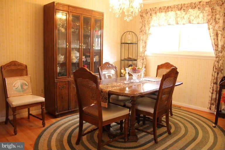 11235 Country Road Dunkirk, MD 20754 - Photo 5 of 8 a view of a dining room with furniture and wooden floor