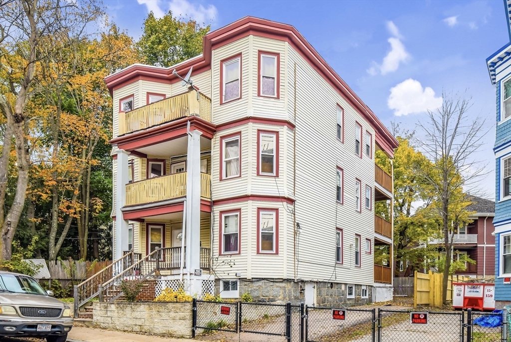 a front view of a residential apartment building with a yard
