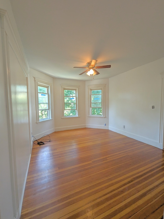 84 Bailey Street Boston, MA 02124 - Photo 4 of 11 an empty room with wooden floor and windows