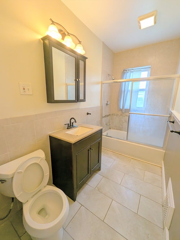 84 Bailey Street Boston, MA 02124 - Photo 7 of 11 a bathroom with a toilet sink vanity granite and mirror