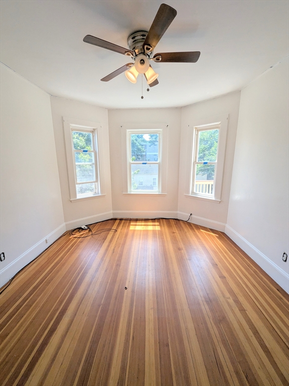 84 Bailey Street Boston, MA 02124 - Photo 10 of 11 an empty room with wooden floor and windows