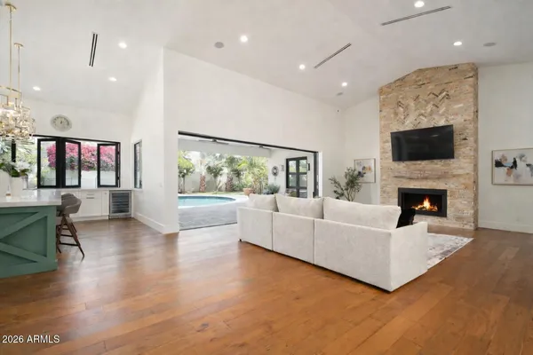 a living room with furniture a fireplace and a flat screen tv