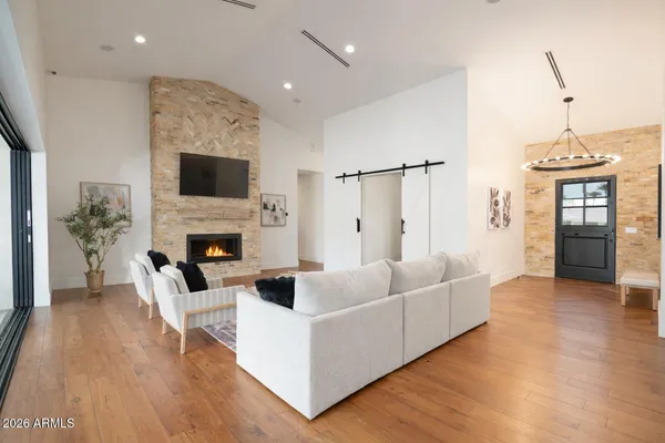 a living room with furniture a fireplace and a flat screen tv