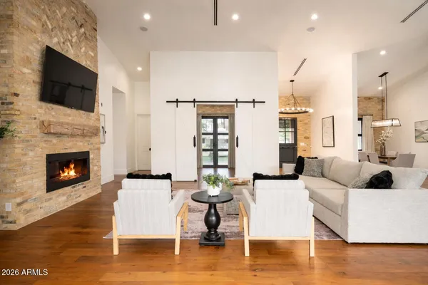 a living room with fireplace furniture and a flat screen tv