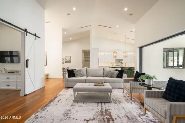 a living room with furniture and wooden floor