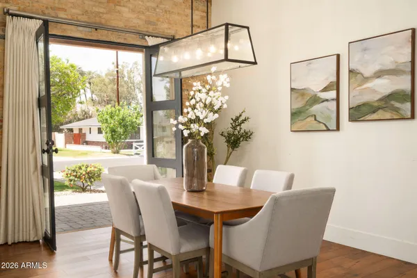 a dining room with furniture and wooden floor