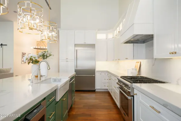 a kitchen with cabinets and stainless steel appliances