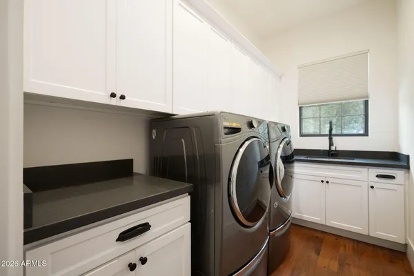 a utility room with sink dryer and washer