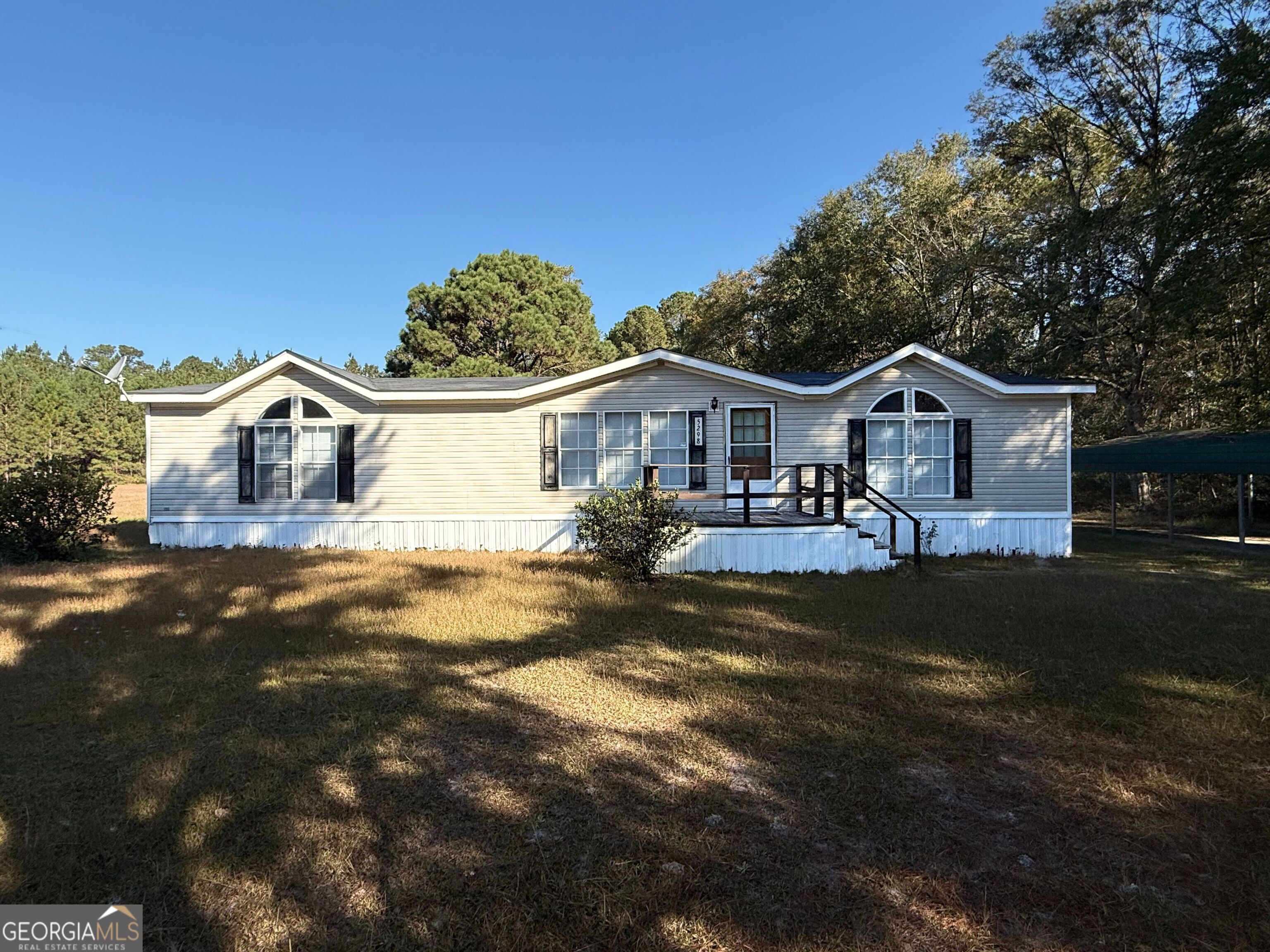 5298 Highway 67 Brooklet, GA 30415 - Photo 1 of 1 a front view of a house with a garden and yard