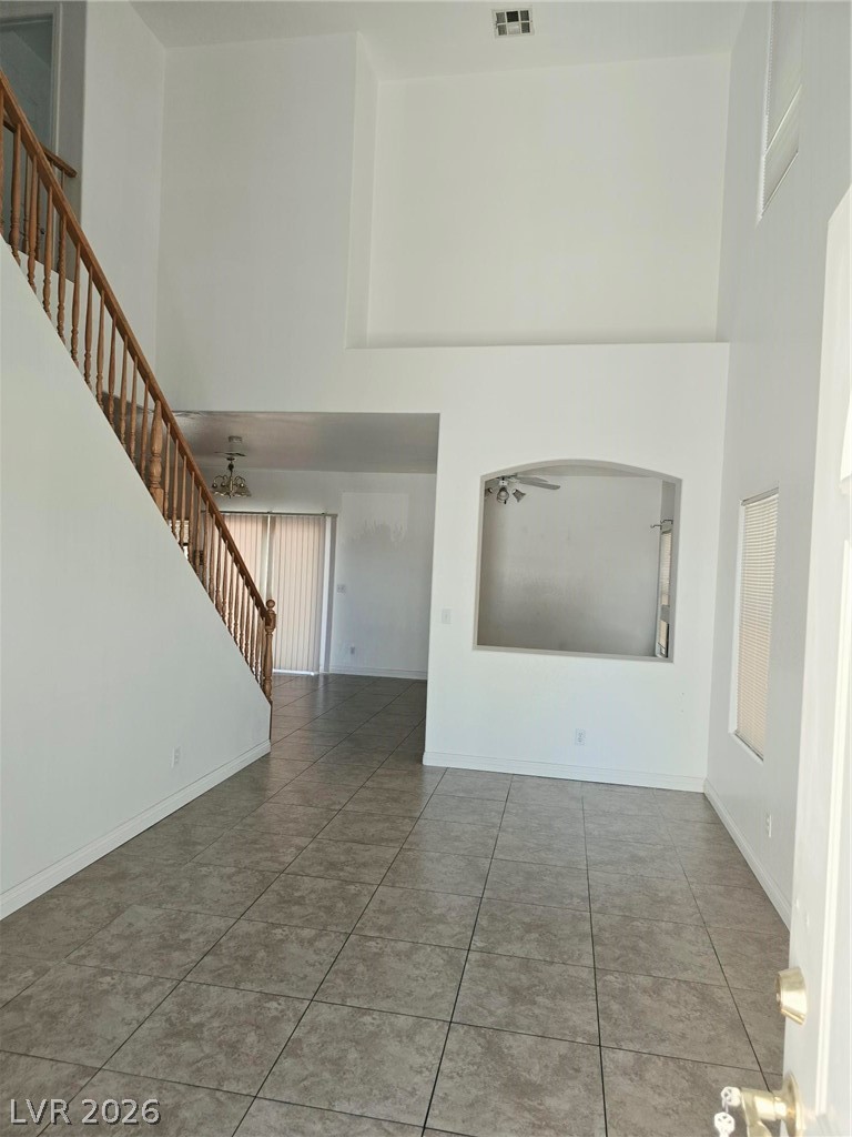 9034 West Rochelle Avenue Las Vegas, NV 89147 - Photo 2 of 8 The soaring vaulted ceilings and sleek tile flooring define this spacious living area.