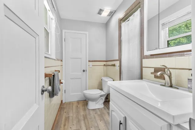 a bathroom with a sink toilet and shower