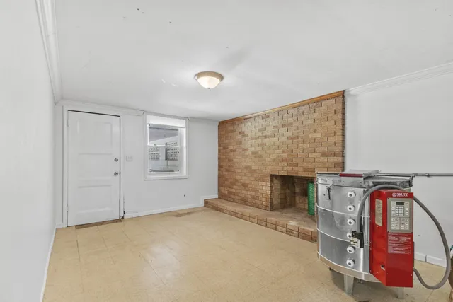 a view of an empty room with a fireplace