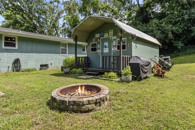 a view of a house with a yard patio and swimming pool