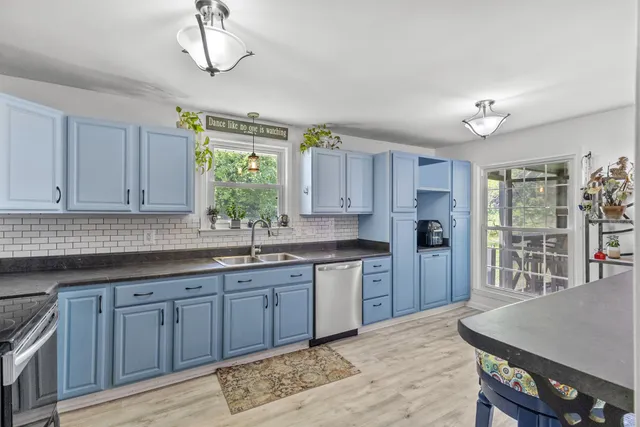 a kitchen with sink cabinets and window