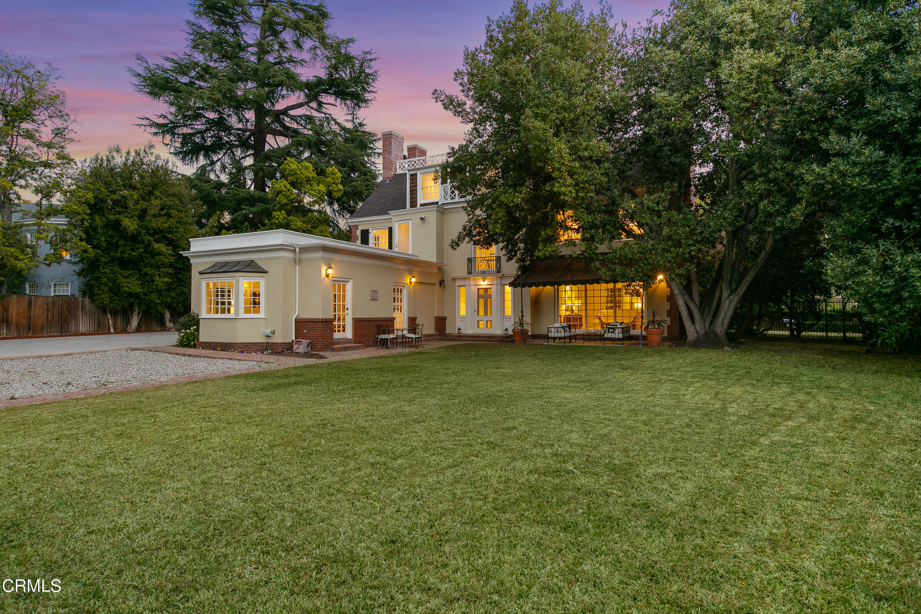 445 Prospect Square Pasadena, CA 91103 - Photo 49 of 55 a view of a white house in front of a big yard with large trees