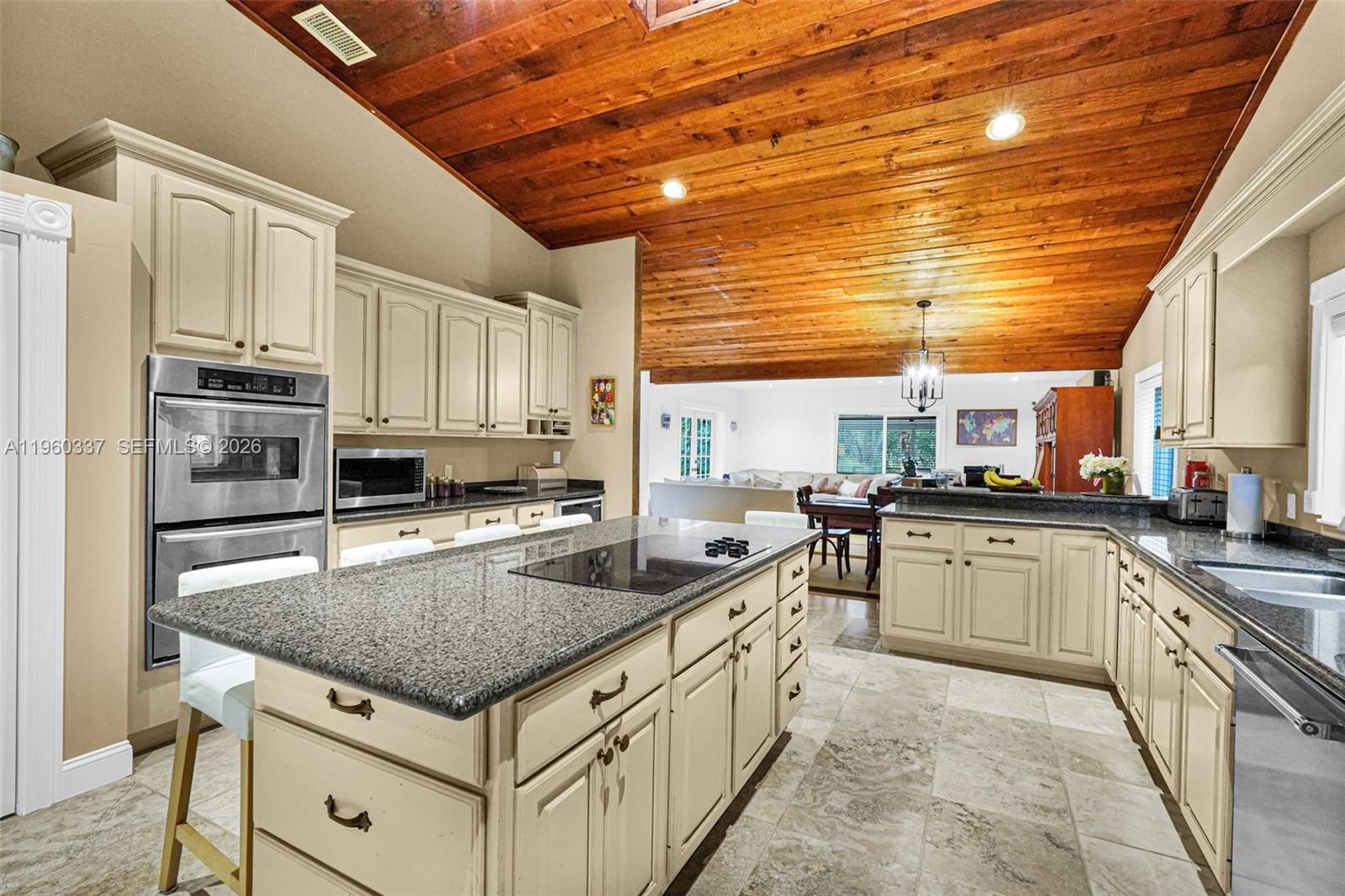 5021 Southwest 168th Avenue Southwest Ranches, FL 33331 - Photo 23 of 88 a kitchen with stainless steel appliances granite countertop a sink stove and refrigerator