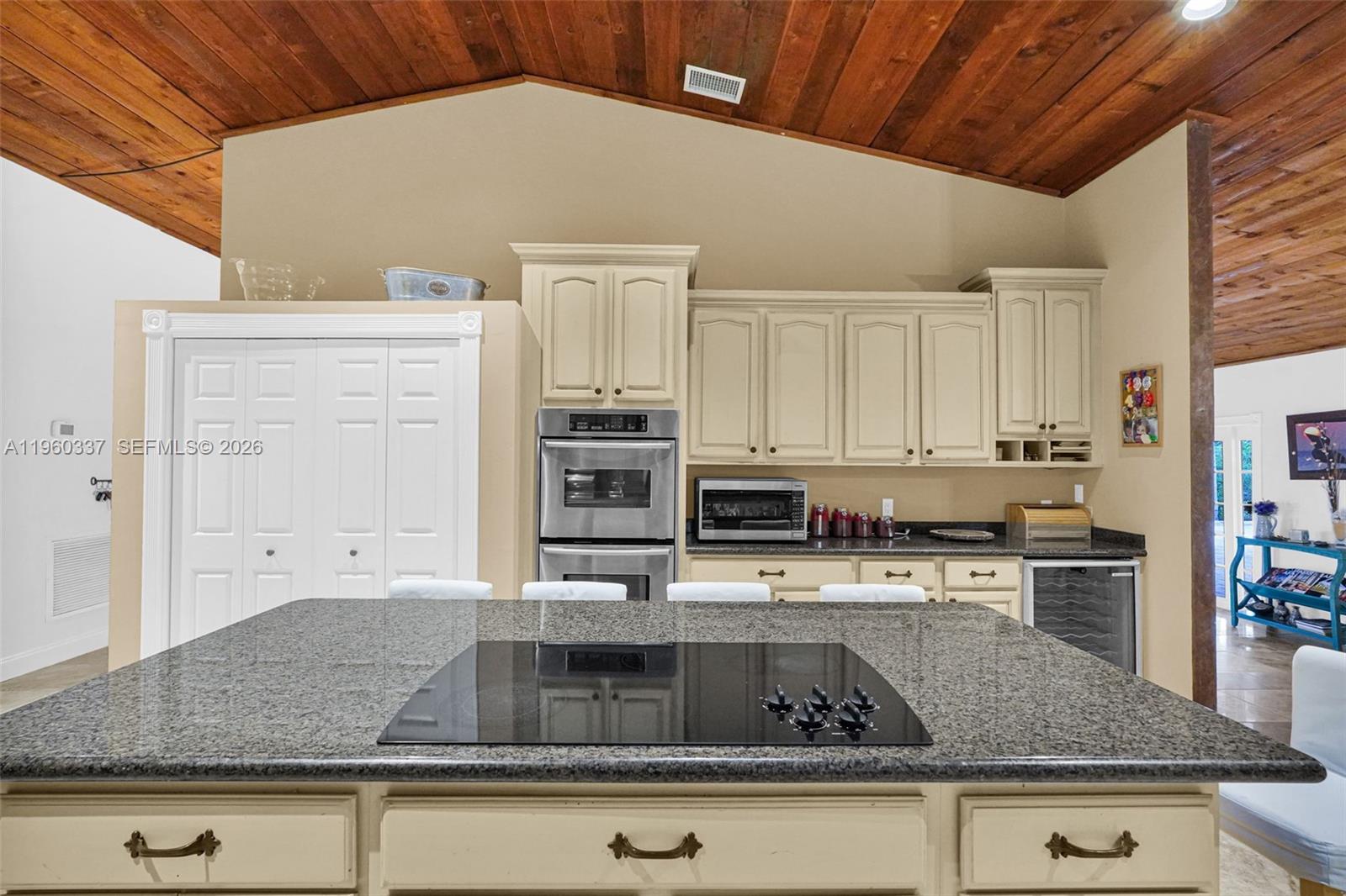 5021 Southwest 168th Avenue Southwest Ranches, FL 33331 - Photo 31 of 88 a kitchen with stainless steel appliances granite countertop a sink a stove and cabinets