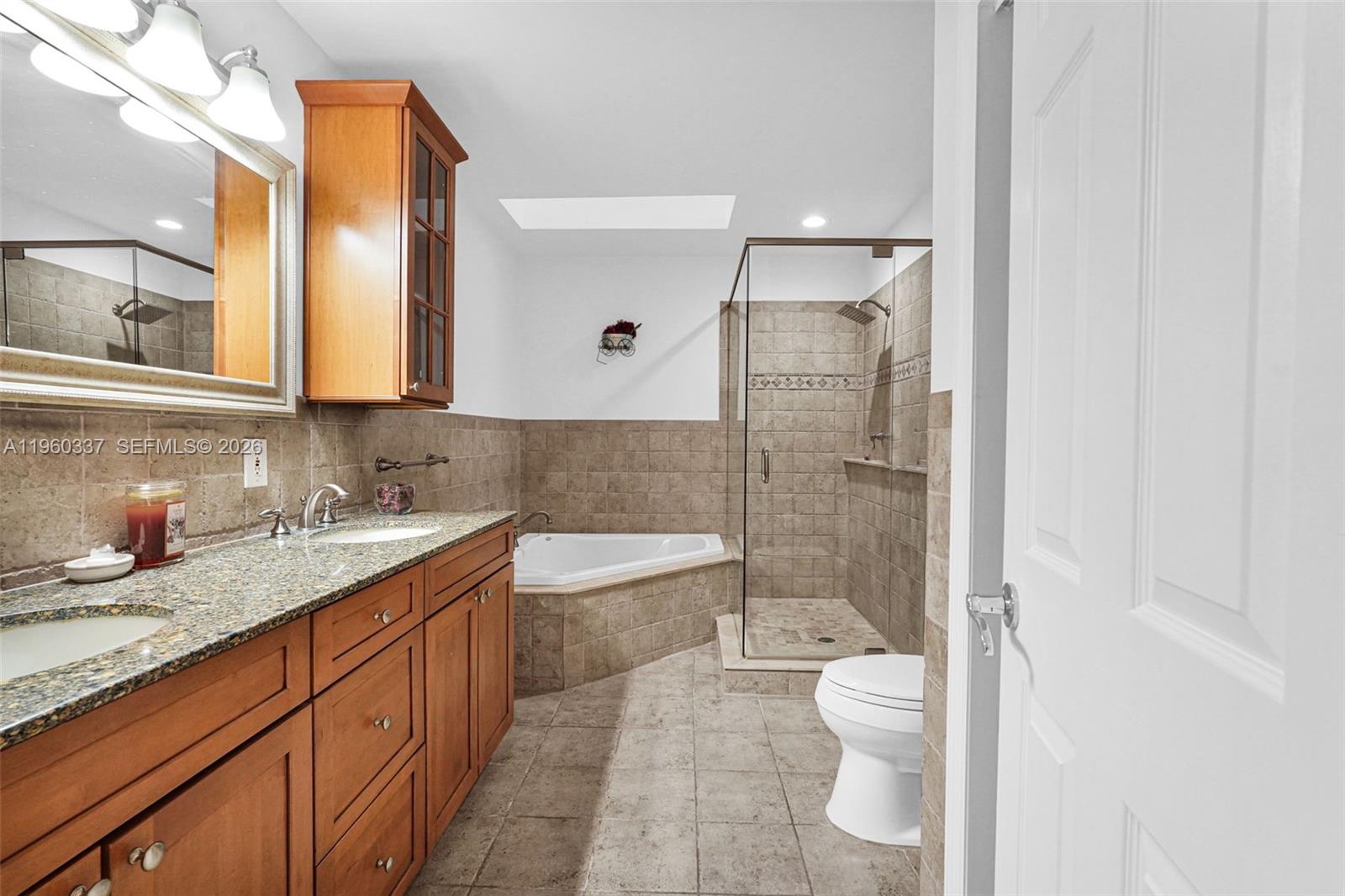 5021 Southwest 168th Avenue Southwest Ranches, FL 33331 - Photo 47 of 88 a bathroom with a granite countertop sink toilet and shower