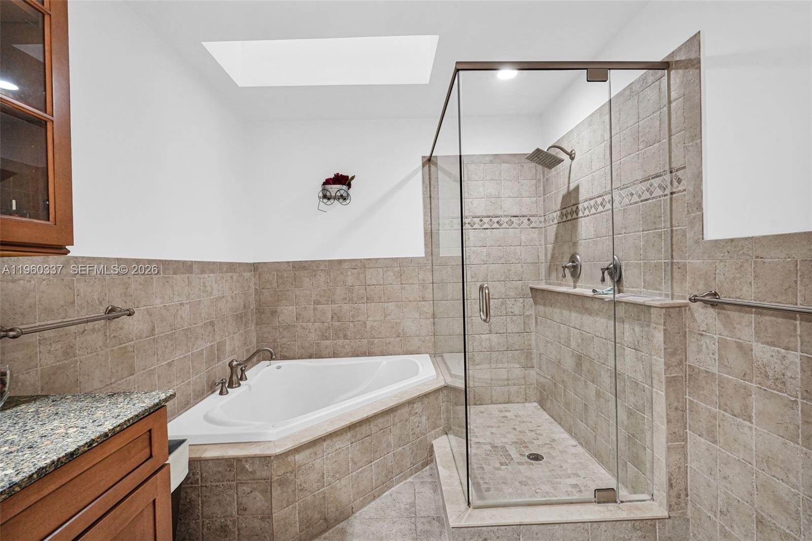 5021 Southwest 168th Avenue Southwest Ranches, FL 33331 - Photo 48 of 88 a bathroom with a granite countertop bathtub shower sink and vanity