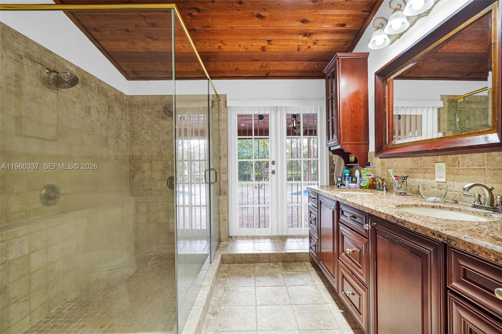 5021 Southwest 168th Avenue Southwest Ranches, FL 33331 - Photo 53 of 88 a bathroom with a granite countertop sink a toilet and shower