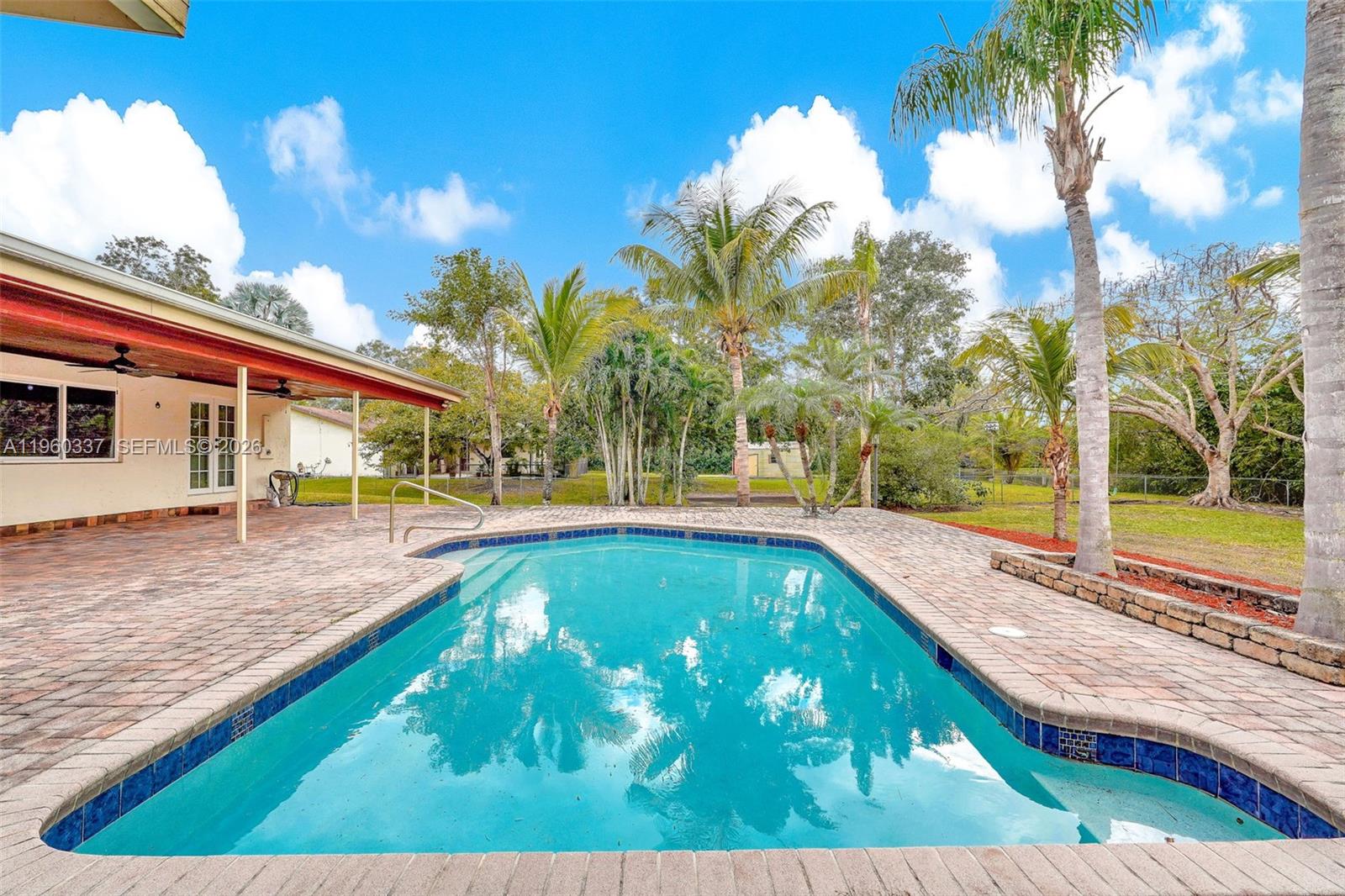 5021 Southwest 168th Avenue Southwest Ranches, FL 33331 - Photo 67 of 88 a view of a swimming pool with a yard