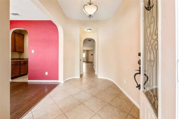 a view of a hallway with wooden floor and entryway