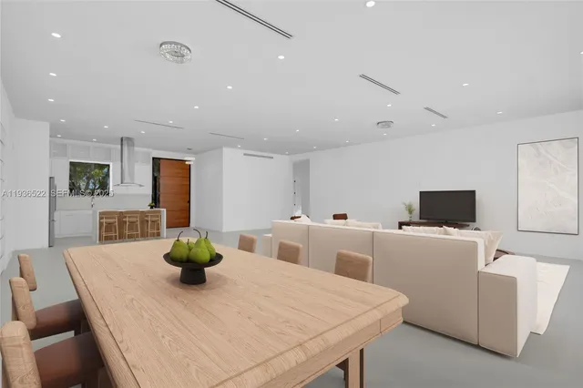 a dining room with furniture and a kitchen view
