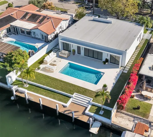 a roof deck with table and chairs