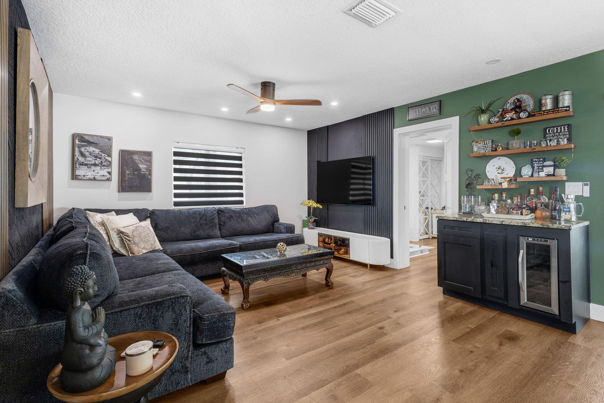 226 Bamboo Road Palm Beach Shores, FL 33404 - Photo 11 of 39 a living room with furniture and a fireplace