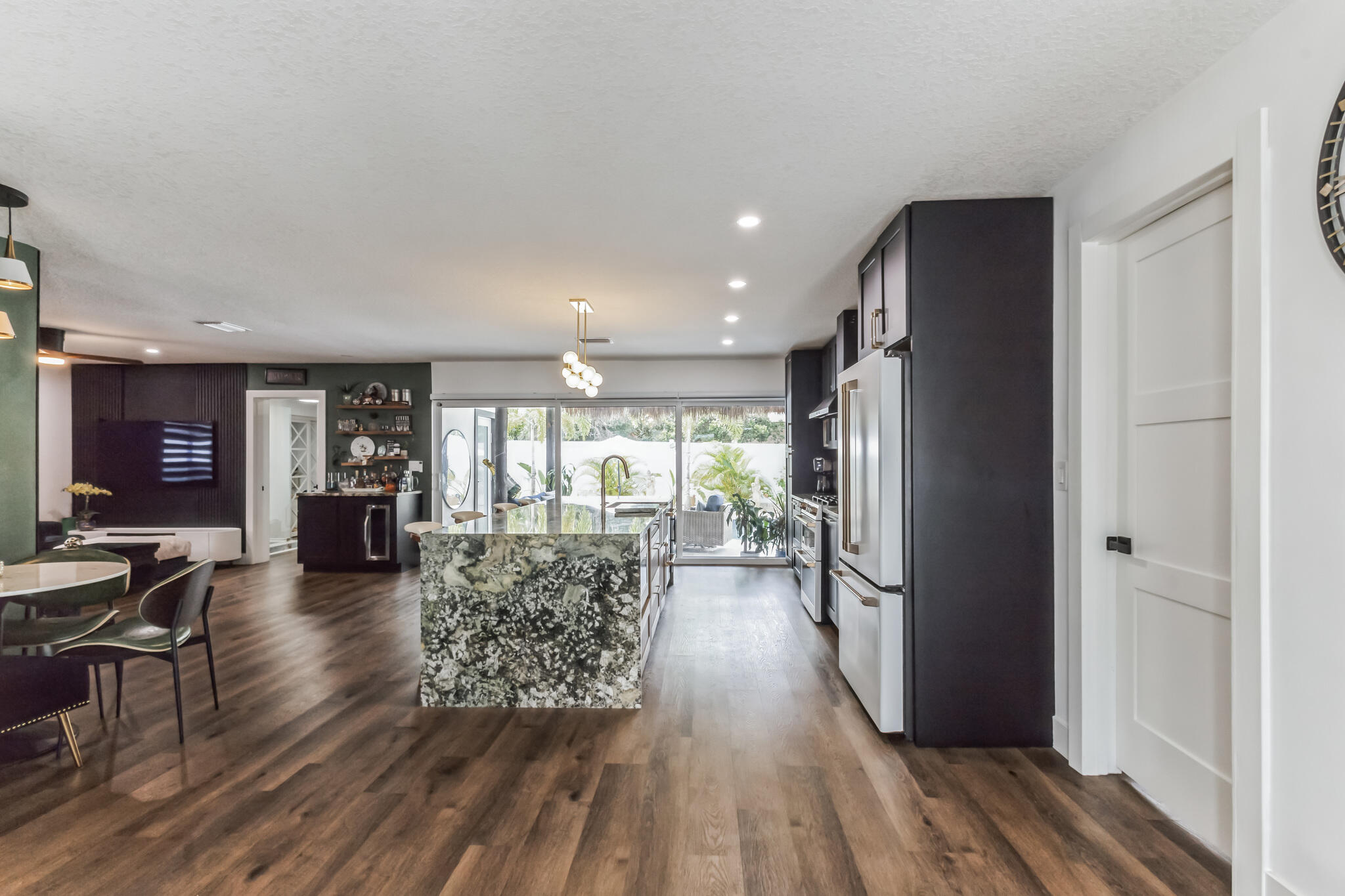 226 Bamboo Road Palm Beach Shores, FL 33404 - Photo 5 of 39 a living room with furniture a large window wooden floor and a rug