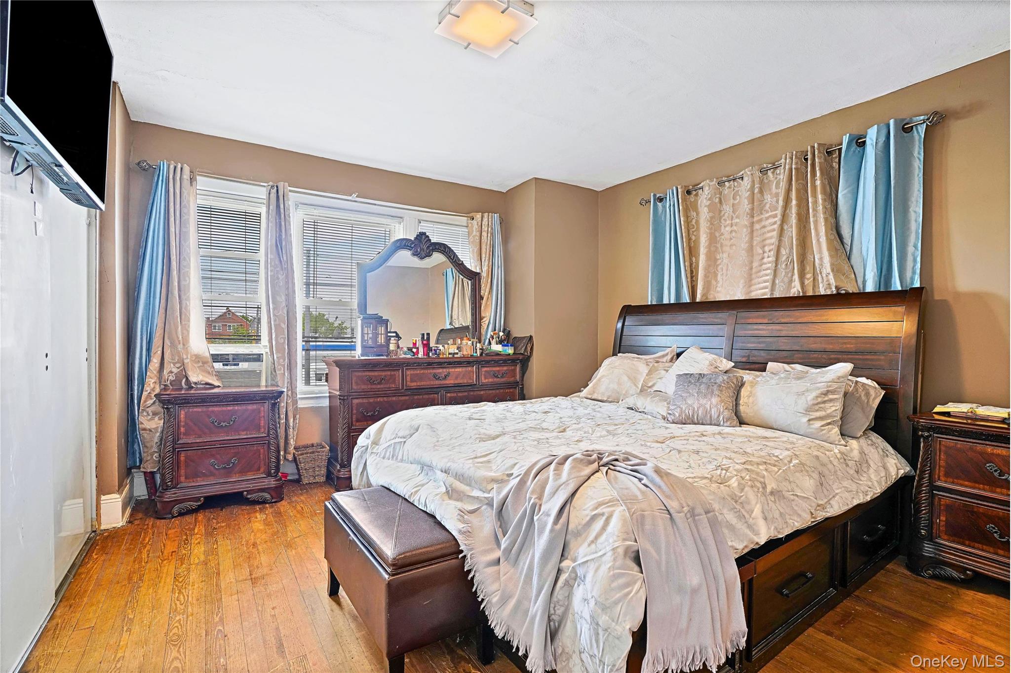 59-11 Fresh Pond Road Queens, NY 11378 - Photo 11 of 18 a bedroom with a bed and wooden floor