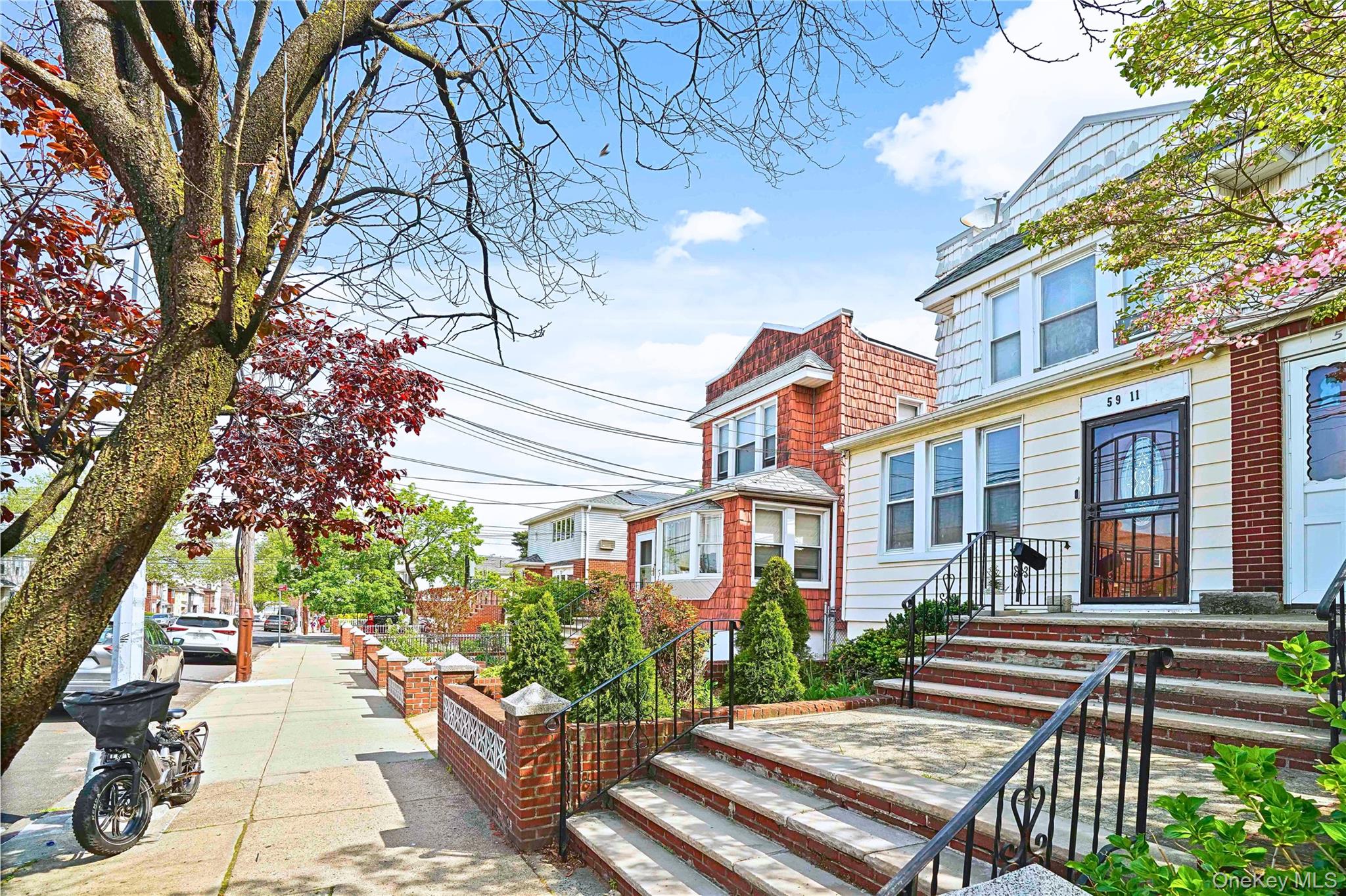 59-11 Fresh Pond Road Queens, NY 11378 - Photo 18 of 18 a front view of a house with a yard