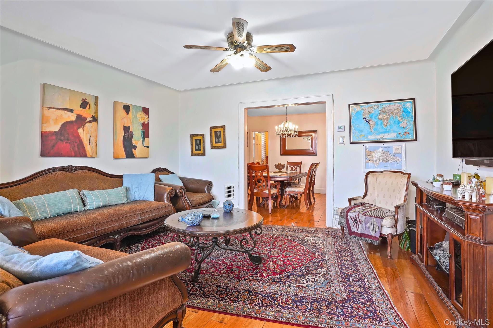 59-11 Fresh Pond Road Queens, NY 11378 - Photo 3 of 18 a living room with furniture a rug and a flat screen tv