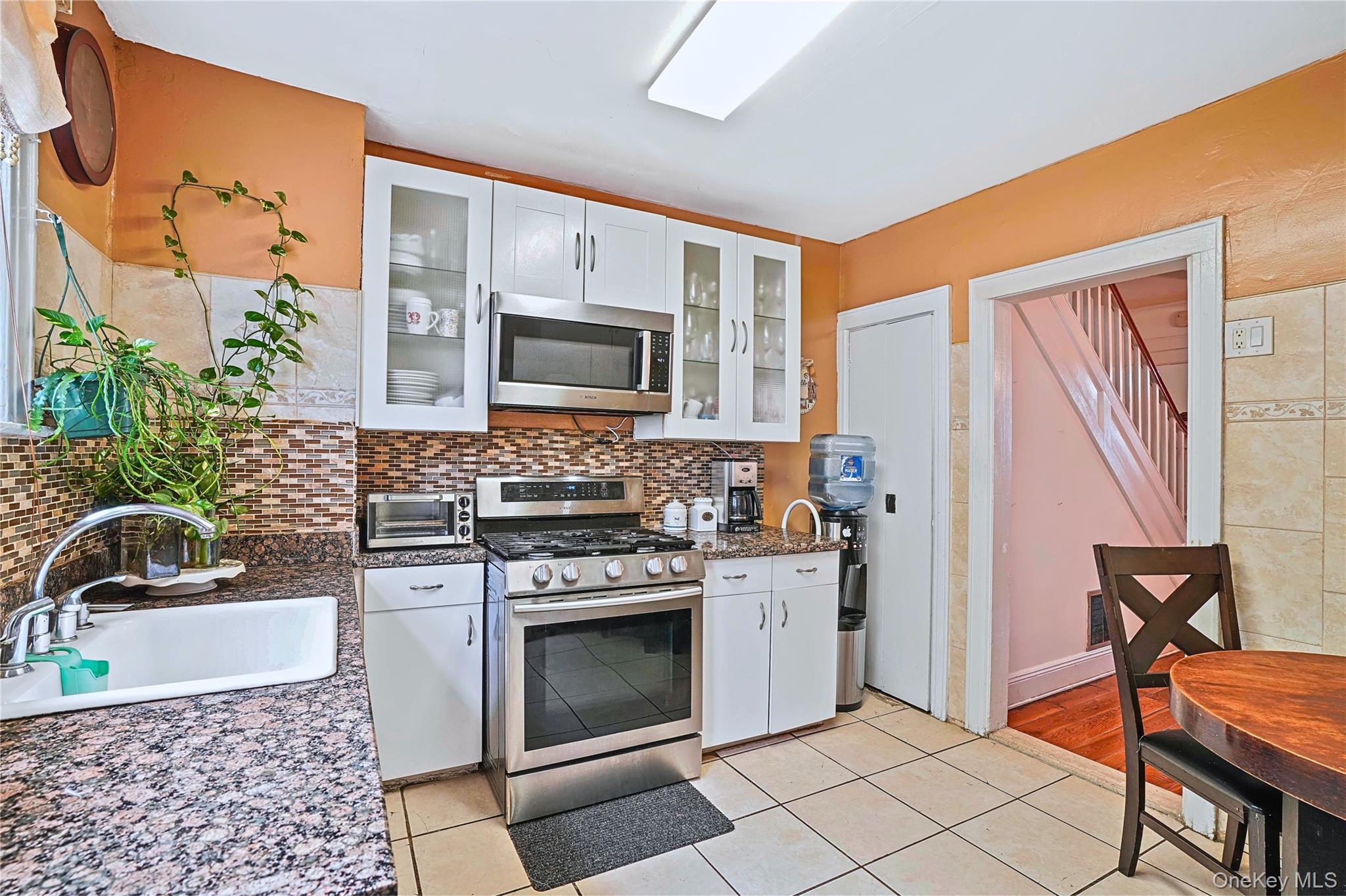 59-11 Fresh Pond Road Queens, NY 11378 - Photo 5 of 18 a kitchen with stainless steel appliances a stove a sink and a microwave