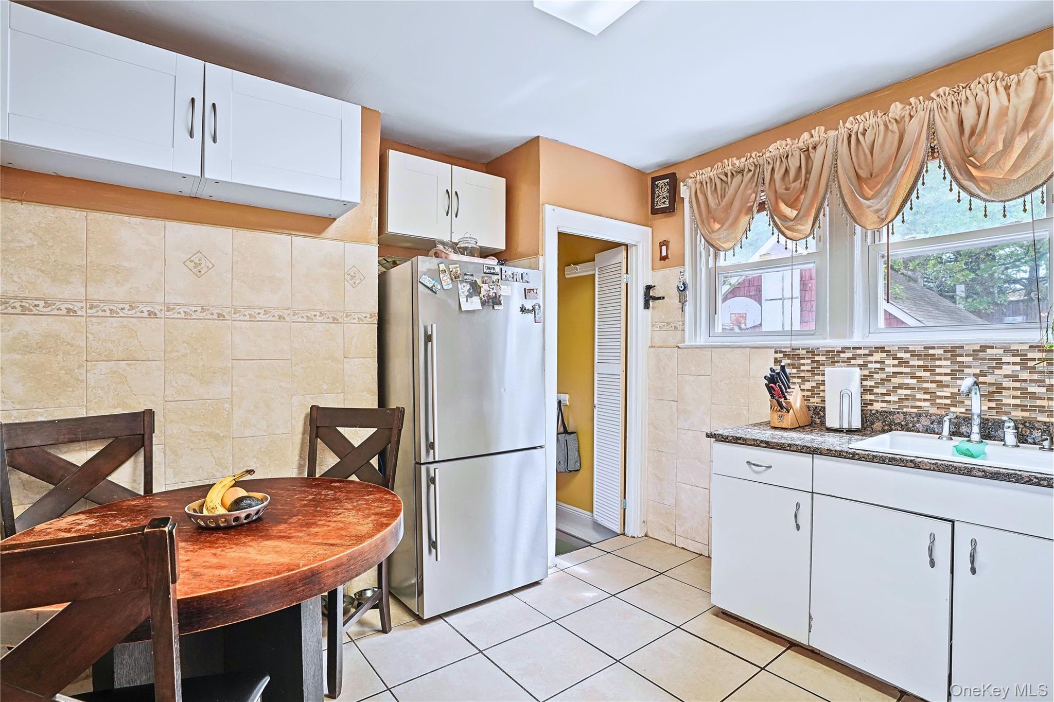 59-11 Fresh Pond Road Queens, NY 11378 - Photo 6 of 18 a kitchen with stainless steel appliances granite countertop a refrigerator and a sink