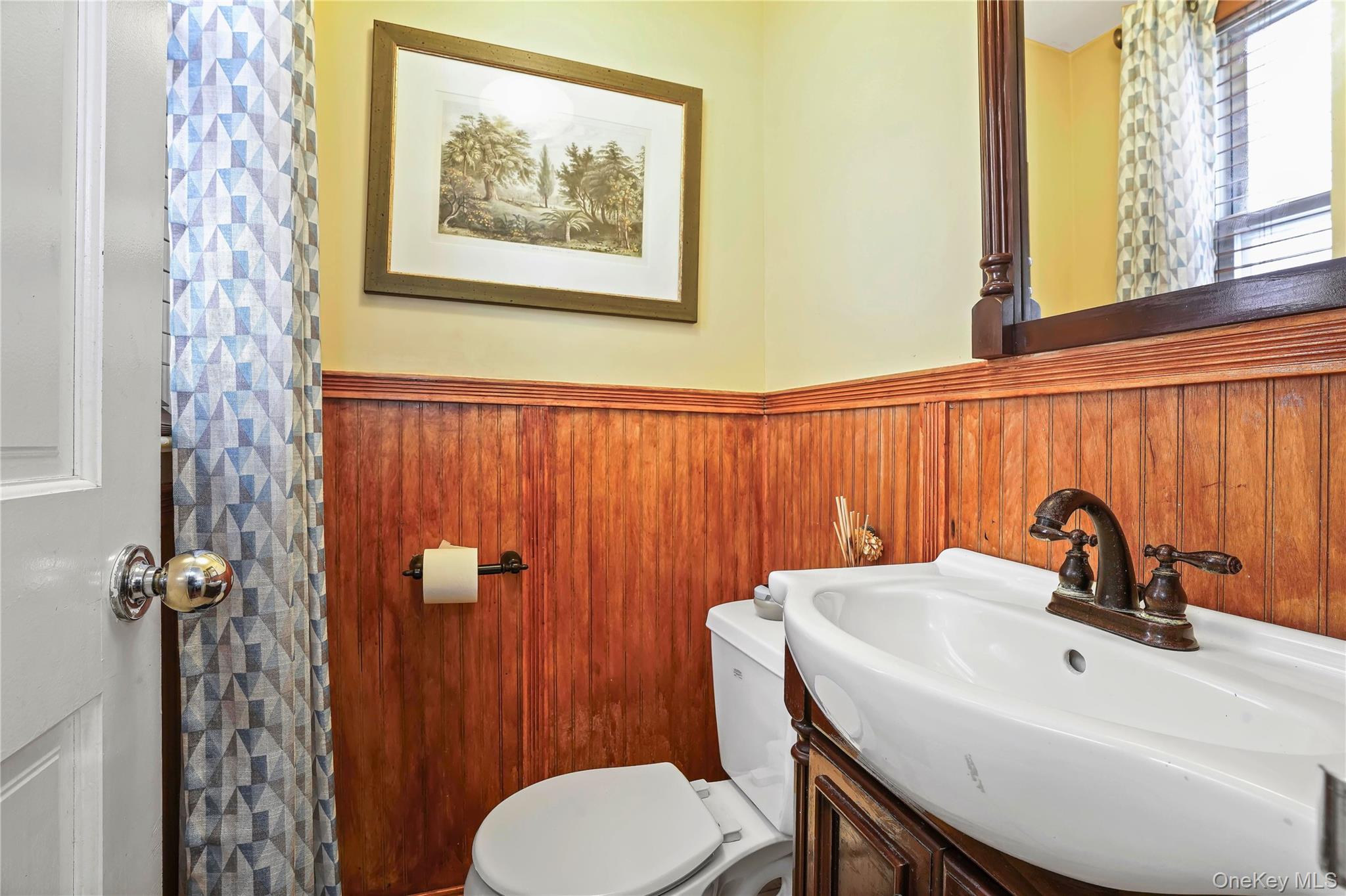 59-11 Fresh Pond Road Queens, NY 11378 - Photo 7 of 18 a bathroom with a sink a toilet and shower curtain
