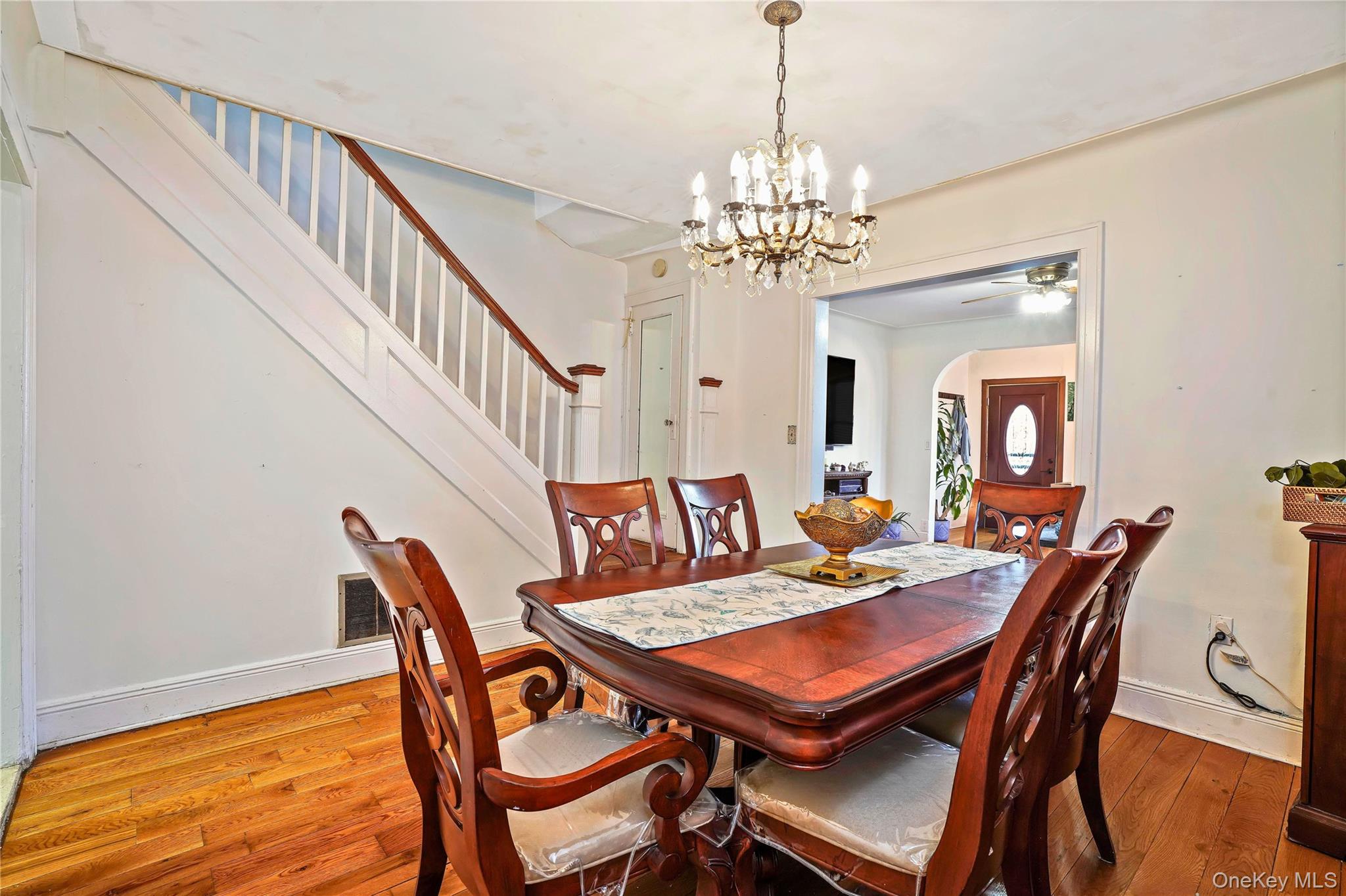 59-11 Fresh Pond Road Queens, NY 11378 - Photo 10 of 18 a view of a dining room with furniture a chandelier and wooden floor