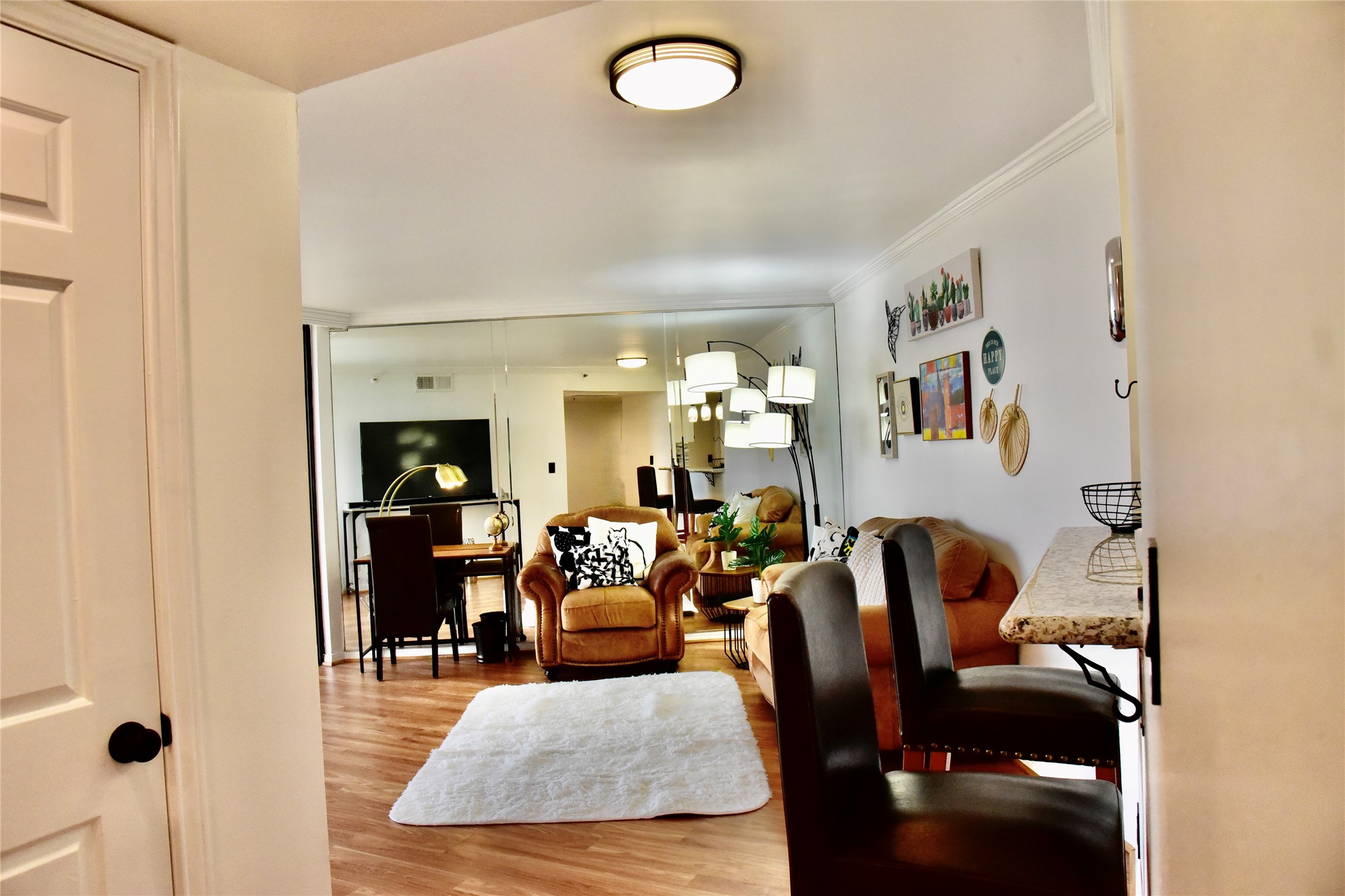 3525 Sage Road, Unit 701 Houston, TX 77056 - Photo 4 of 48 Cozy, well-lit living space with warm decor, tasteful wall art, ideal for relaxation or entertaining guests.