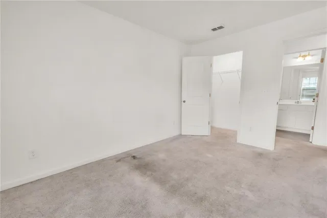 an empty room with a empty space and windows