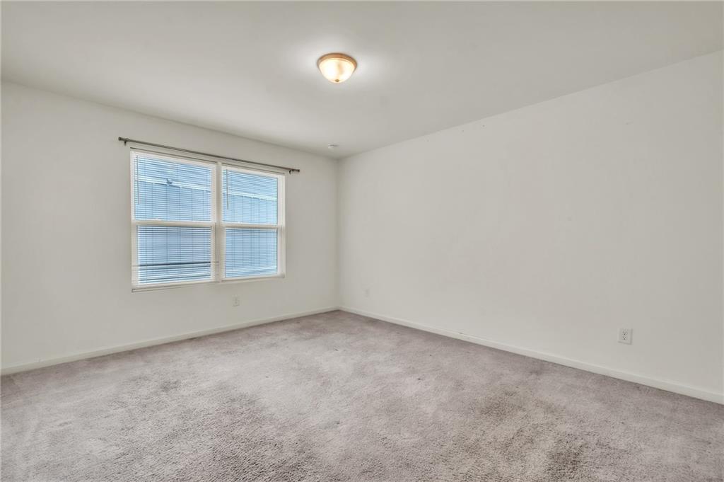 1517 Vernon Boulevard Decatur, GA 30035 - Photo 14 of 25 an empty room with a empty space and windows
