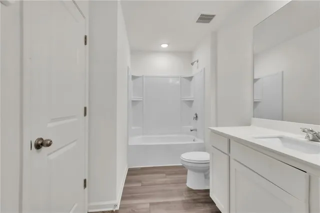 a bathroom with a sink and mirror with toilet